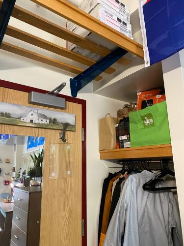 Close view of clothes hangers and other storage space