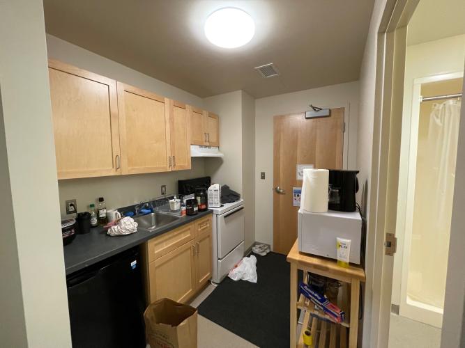 Kitchen and entryway. Extra shelving to hold microwave