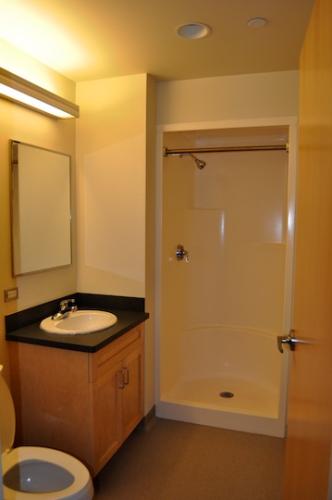 Bathroom with under-sink storage and a shower (no bathtub)