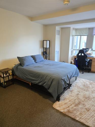 queen sized bed with lamp next to it