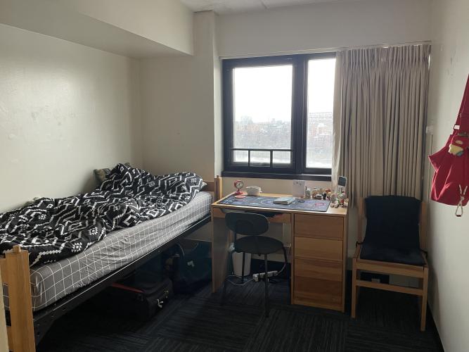 Bedroom layout. The bed is to the left upon entrance and the desk is straight ahead, before the window.