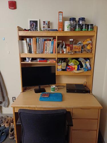 Desk and shelving unit above the desk