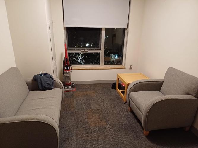 Couch and armchair with coffee table; this is the communal seating area next to the kitchen area.