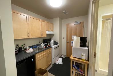 Kitchen and entryway. Extra shelving to hold microwave